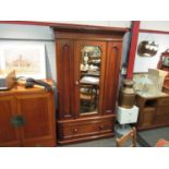 A Victorian walnut single wardrobe, the mirror door with key over a single base drawer,