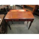 Circa 1860 a mahogany side table the two frieze drawers over turned and tapering legs 91cm x 44cm x