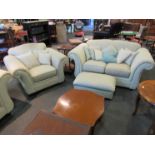 A suite comprising of two sofas, two armchairs and a footstool,