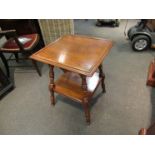 A late Victorian walnut two tier lamp table on turned leg supports,