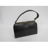A classic black leather lizard skin handbag