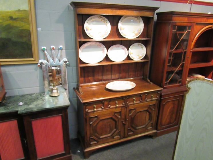 An oak dresser with plate rack back, two drawer on two cupboard door base,