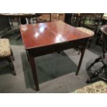 A mahogany tea table with arched supports,