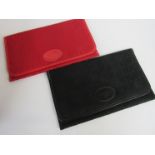 Two vintage Louis Feraud fabric and leather clutch bags with the LF logo pattern in red and black