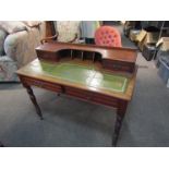 An Edwardian mahogany lady's desk with pigeon hole and drawer back, leather inset top,