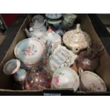 A box containing teapots, crockery,
