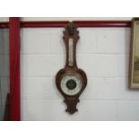 An early 20th Century aneroid barometer with presentation plaque