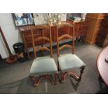 A 19th Century set of six French fruitwood ladder-back dining chairs on turned legs joined by an