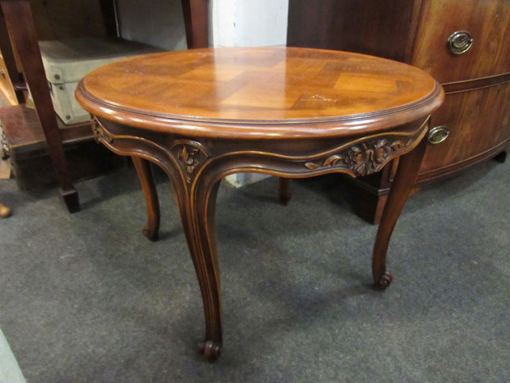 A French style parquetry circular top occasional table on carved cabriole legs,