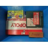 A box containing games including Monopoly