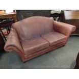 A brown leather two seater sofa,