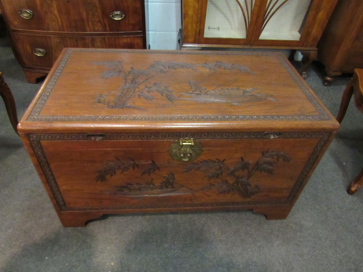 A mid 20th Century Southeast Asia camphor wood trunk with carved decoration and sliding tray (with - Image 2 of 3