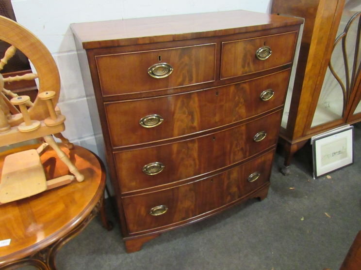 A circa 1840 flame mahogany bow front chest of two short over three drawers,