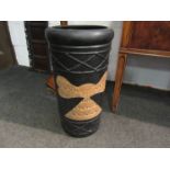 A cylindrical craft pottery stick stand with fish and Aztec design,