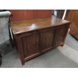 An oak 18th Century style coffer the hinged lid over a panelled base on stile feet,