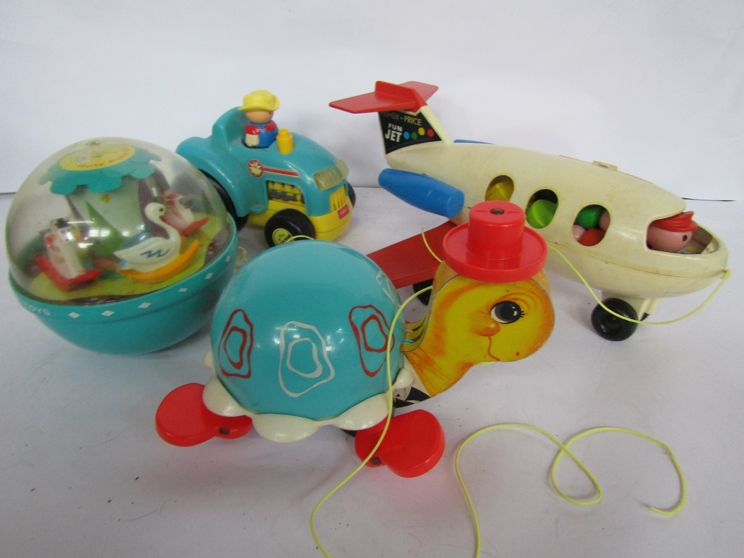 A box containing Fisher Price toys including Fun Jet and Roly Poly Chime ball