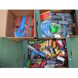 A box of Thomas & Friends locomotives and rolling stock together with engine sheds,