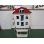 An early 20th Century painted wooden dolls house