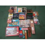 A large collection of mixed games and puzzles including Lexcon, dominoes, cribbage, Rummikub,