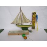 Mixed vintage toys including pond yacht, yo-yos, circus monkey,