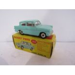 A boxed Dinky diecast 155 Ford Anglia in turquoise with red interior