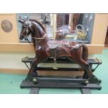 A brown gloss painted rocking horse on trestle rocker, horse hair mane,