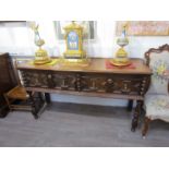 A 17th Century style country oak sideboard, geometric fronted twin drawers, turned legs,