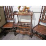 A Victorian walnut Canterbury what-not with barley twist supports and single drawer,