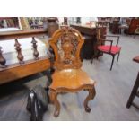 A pair of 19th Century hall chairs with pierced shield backs,