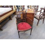 A Victorian inlaid mahogany and rosewood open arm lady's armchair with turned spindle backrest over