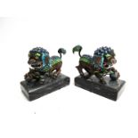 A pair of miniature dogs of fo figures with bright enamel detail,