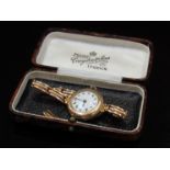A 1920's 9ct rose gold lady's wristwatch on expanding bracelet,