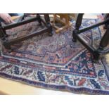 An Eastern wool rug, blue ground central terracotta medallion, cream geometric border, fringing,