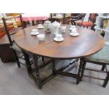 An 18th Century oak gate-leg dining table, turned supports,