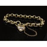 A gold engraved link bracelet with pierced heart padlock set with a row of diamonds (one missing),