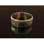 A 9ct gold engraved band, 6mm wide. Size R, 2.