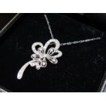 A 9ct white gold pendant encrusted with 35 diamonds in a floral design on a 46cm long white gold