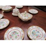 A 19th Century part dinner service decorated in bright colours with flowers and insects including