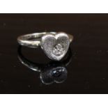 A white gold and 0.05 diamonds heart ring, stamped 9ct. Size O, 2.