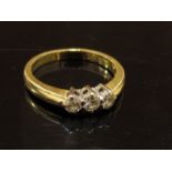 An 18ct gold three stone diamond ring, .33ct total. Size L/M, 3.