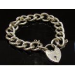 A heavy silver curb link bracelet with padlock,