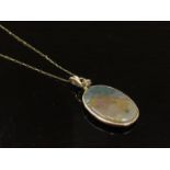 A gold neck chain 52cm long 0.9g stamped 9k hung with an oval agate pendant, 3cm x 2.