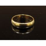 A gold wedding band, unmarked. Size O/P, 5.