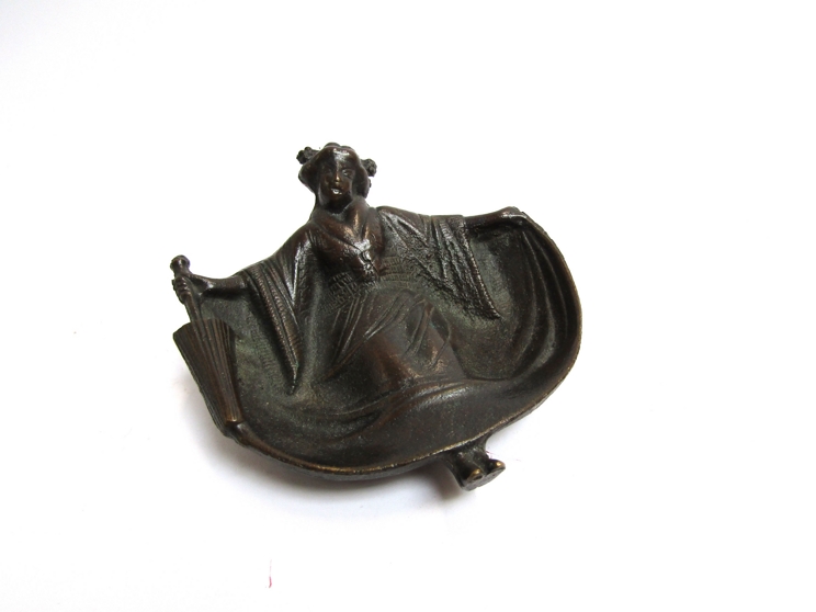 A cast metal Oriental female ashtray with surprise verso!!! 12cm wide