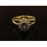 A 14ct gold sapphire and diamond ring, the central sapphire framed by diamonds. Size P, 3.