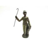A cast metal figure man with top hat and cane,