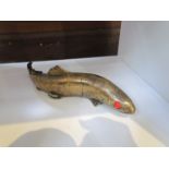 A Bergman brass fish with red eyes, stamp to base,