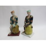 Two Japanese ceramic Kutani figures seated on barrels 24cm tall