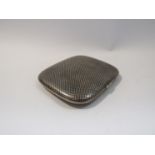 An Arabian silver Niello cigarette case with chequered pattern to top,