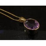 A 9ct gold pendant set with faceted amethyst stone on fine 9ct gold chain, 48cm long,